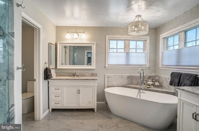 bathroom featuring an enclosed shower, toilet, a freestanding bath, marble finish floor, and vanity