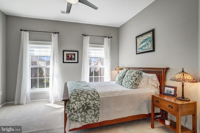 bedroom with baseboards, carpet floors, a ceiling fan, and visible vents
