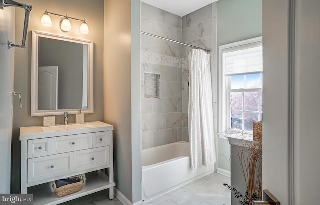 full bathroom featuring vanity, shower / tub combo, marble finish floor, and baseboards
