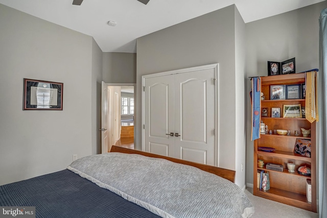 carpeted bedroom with a closet and a ceiling fan