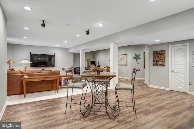 dining area featuring light wood-style flooring, baseboards, and recessed lighting
