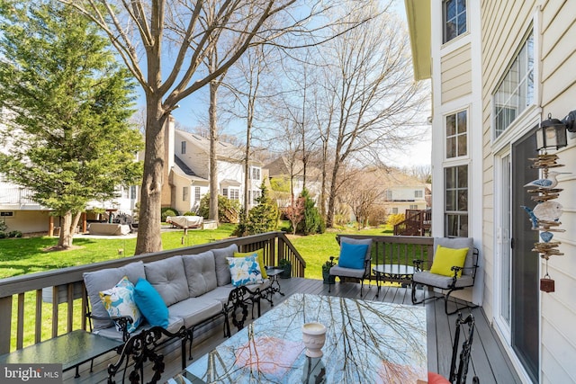 wooden terrace with a lawn, outdoor lounge area, and a residential view