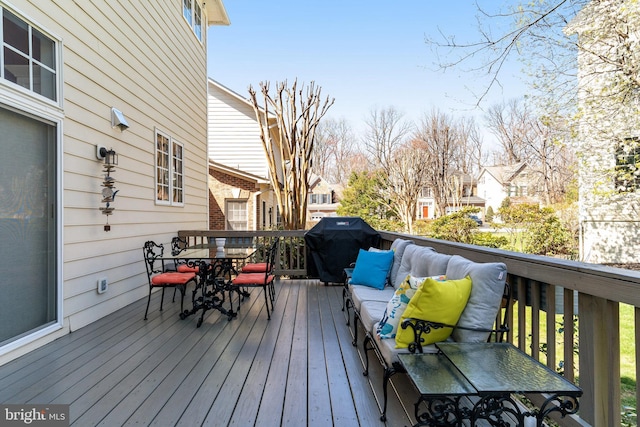 wooden deck featuring a residential view, area for grilling, and outdoor dining area