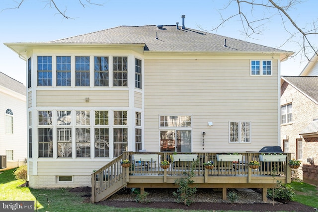 rear view of house with a wooden deck and central AC