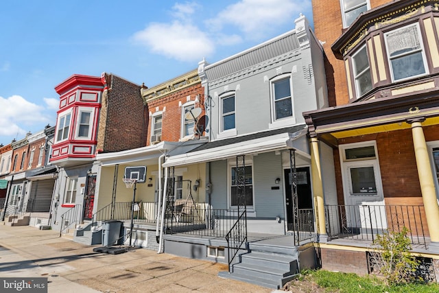 view of property with covered porch and a residential view