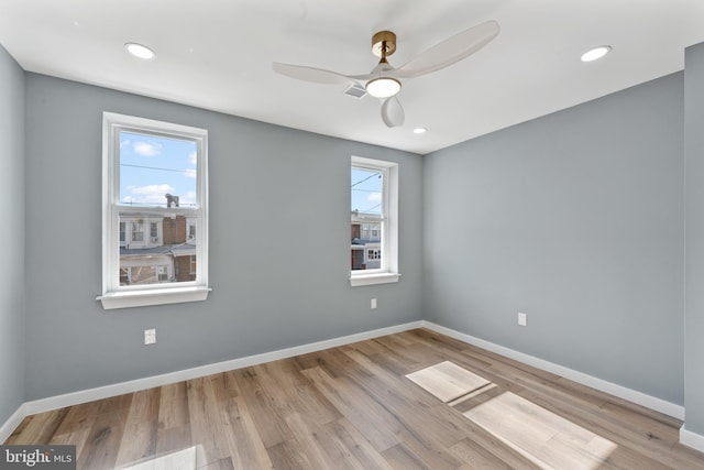 unfurnished room featuring baseboards, wood finished floors, and a ceiling fan