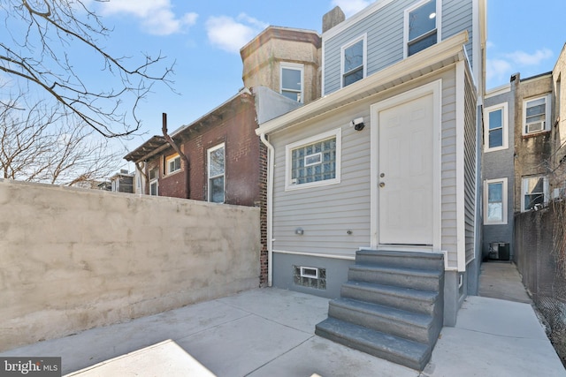 back of property featuring a patio area, fence, and entry steps
