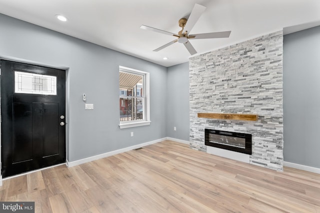 foyer featuring recessed lighting, baseboards, a large fireplace, a ceiling fan, and wood finished floors