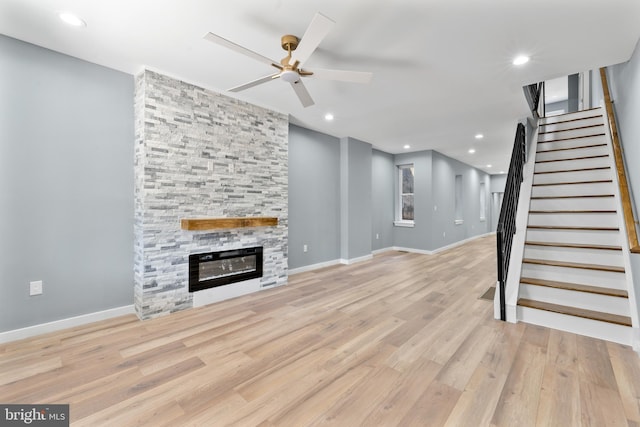 unfurnished living room with stairway, recessed lighting, baseboards, a ceiling fan, and wood finished floors
