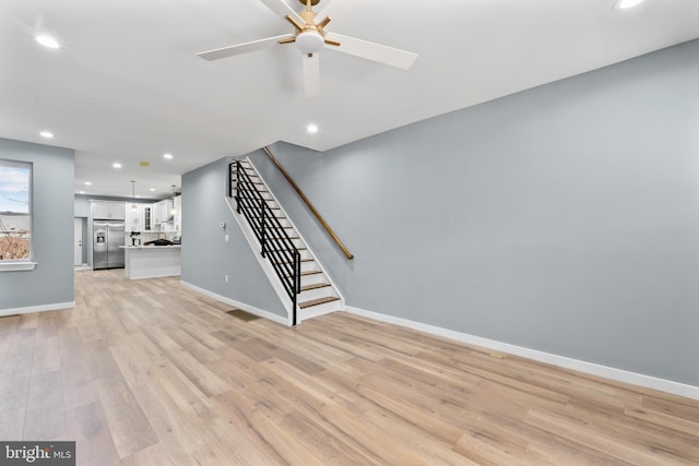 unfurnished living room with stairway, light wood-style flooring, recessed lighting, and a ceiling fan