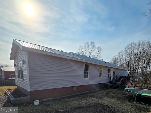 14248 Cunningham Dr SW, Cumberland, MD 21502 - rear view of property with a trampoline, metal roof, and a wooden deck