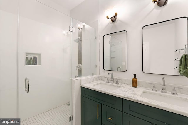 bathroom with double vanity, a sink, and a stall shower