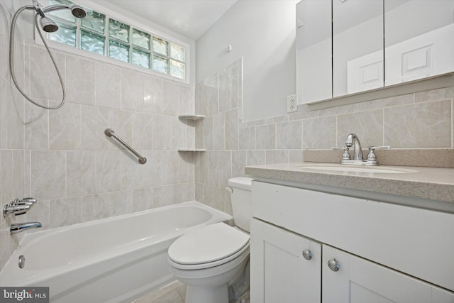 full bath featuring vanity, shower / bathing tub combination, toilet, and tile walls