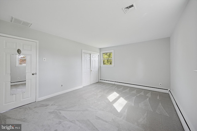 carpeted empty room with visible vents, baseboards, and baseboard heating