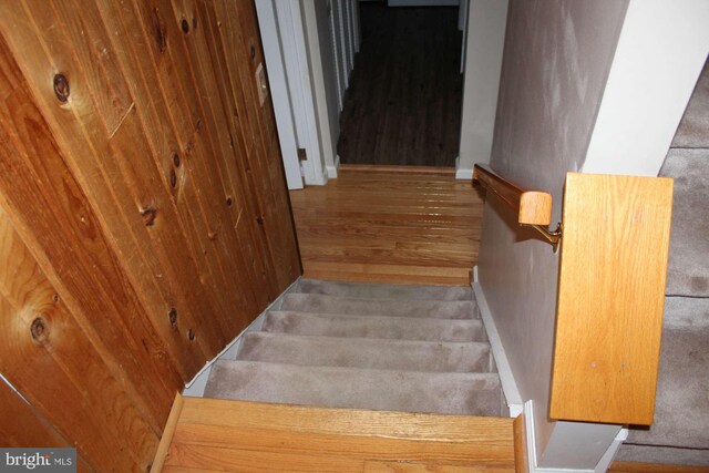 stairway featuring baseboards and wood finished floors