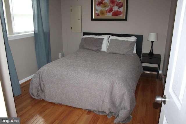 bedroom featuring wood finished floors and baseboards