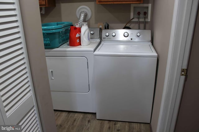 washroom featuring laundry area, separate washer and dryer, and wood finished floors