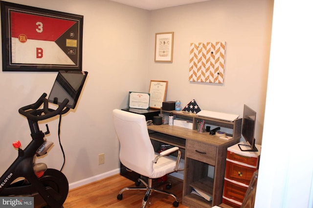 office space featuring baseboards and wood finished floors