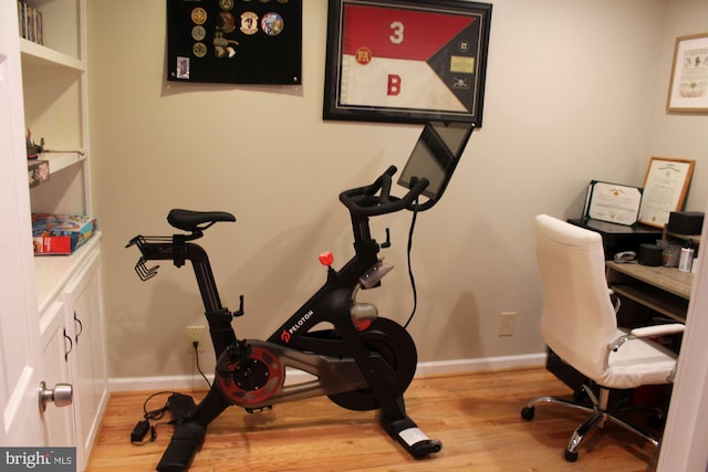 office space with wood finished floors and baseboards