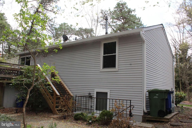 rear view of property featuring stairway