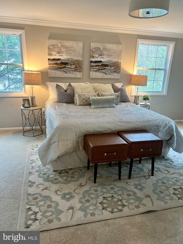 carpeted bedroom with baseboards and ornamental molding