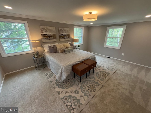 carpeted bedroom with recessed lighting, crown molding, baseboards, and visible vents