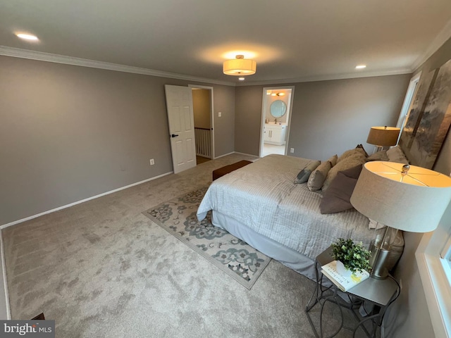 carpeted bedroom with ornamental molding, ensuite bath, and baseboards