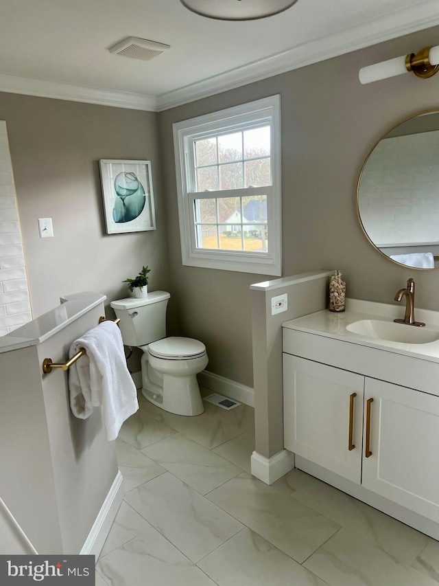 bathroom featuring vanity, crown molding, toilet, baseboards, and marble finish floor