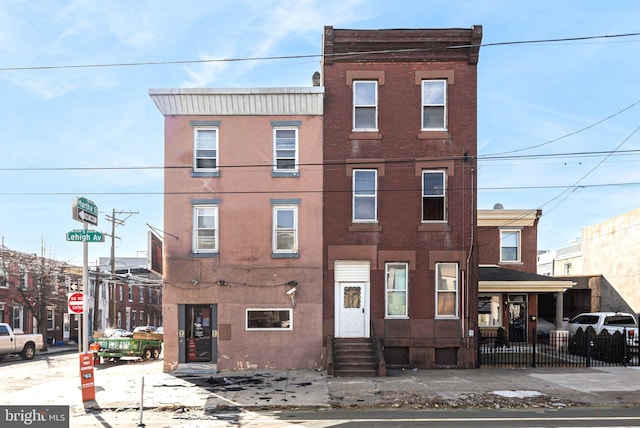 2126 E Lehigh Ave, Philadelphia, PA 19125 - view of property with brick siding, fence, and entry steps