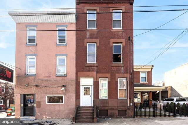 2124-2126 E Lehigh Ave, Philadelphia, PA 19125 - view of property with brick siding, fence, and entry steps