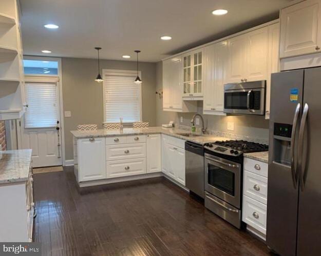 713 S Decker Ave, Baltimore, MD 21224 - kitchen with stainless steel appliances, a sink, a peninsula, white cabinets, and recessed lighting