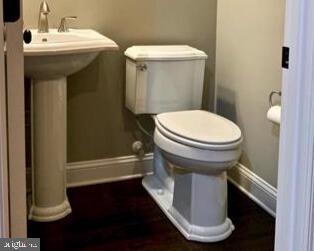 713 S Decker Ave, Baltimore, MD 21224 - bathroom with baseboards, toilet, and a sink