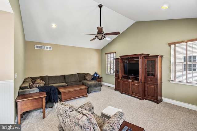 living area with lofted ceiling, visible vents, light colored carpet, and ceiling fan