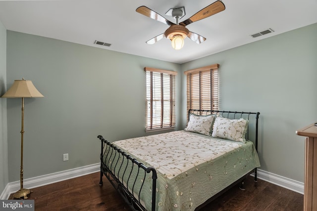 bedroom with wood finished floors, baseboards, and visible vents