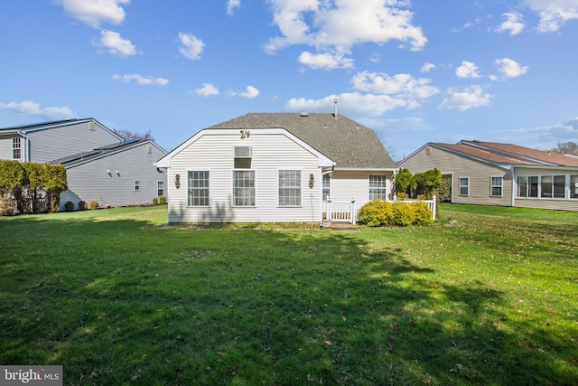 back of house featuring a lawn