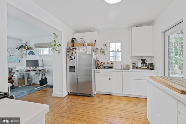 kitchen with dishwasher, a healthy amount of sunlight, and stainless steel fridge with ice dispenser