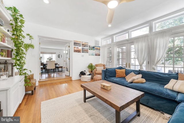 living room featuring recessed lighting, ceiling fan, and light wood-style floors