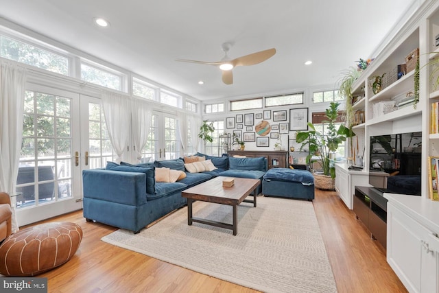living area featuring french doors, a ceiling fan, light wood finished floors, and recessed lighting