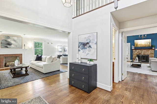 living room featuring a fireplace, wood finished floors, and baseboards