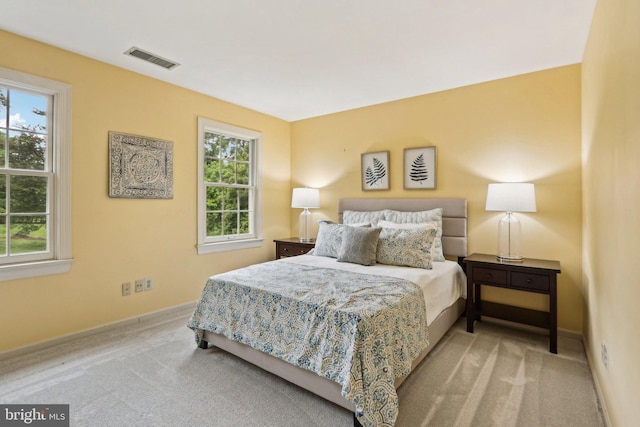 bedroom with multiple windows, carpet flooring, and baseboards