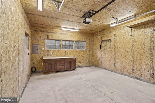 garage featuring a garage door opener and electric panel