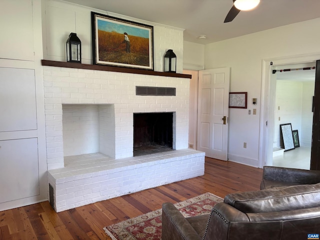 3716 Etlan Rd, Etlan, VA 22719 - living room featuring wood finished floors, a ceiling fan, and a brick fireplace