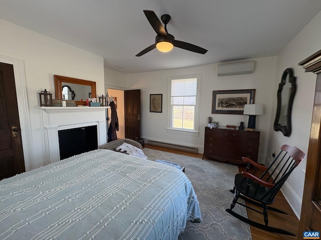 3716 Etlan Rd, Etlan, VA 22719 - bedroom with a baseboard radiator, a wall mounted air conditioner, wood finished floors, and baseboards