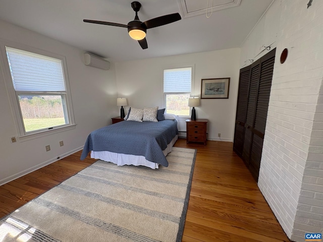 3716 Etlan Rd, Etlan, VA 22719 - bedroom with a wall mounted air conditioner, multiple windows, light wood-style flooring, and attic access