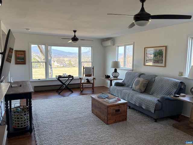 3716 Etlan Rd, Etlan, VA 22719 - living area with a ceiling fan, a wall unit AC, wood finished floors, and baseboard heating
