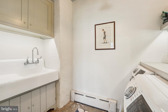 laundry area with a baseboard heating unit, washing machine and dryer, and cabinet space