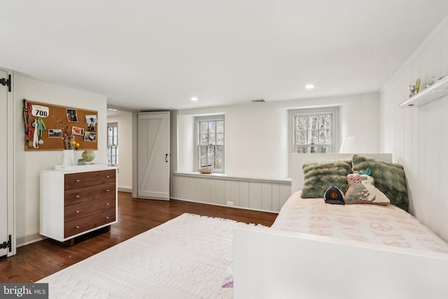 bedroom with dark wood finished floors and recessed lighting