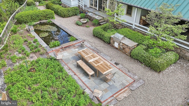 view from above of property featuring a garden pond