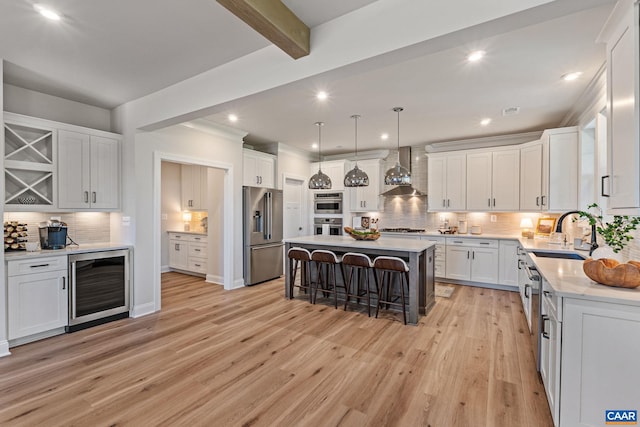 13A Sablewood Dr, Charlottesville, VA 22911 - kitchen with wine cooler, wall chimney exhaust hood, appliances with stainless steel finishes, a sink, and a kitchen breakfast bar