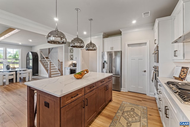 13A Sablewood Dr, Charlottesville, VA 22911 - kitchen featuring a kitchen island, light wood-type flooring, stainless steel appliances, visible vents, and white cabinets